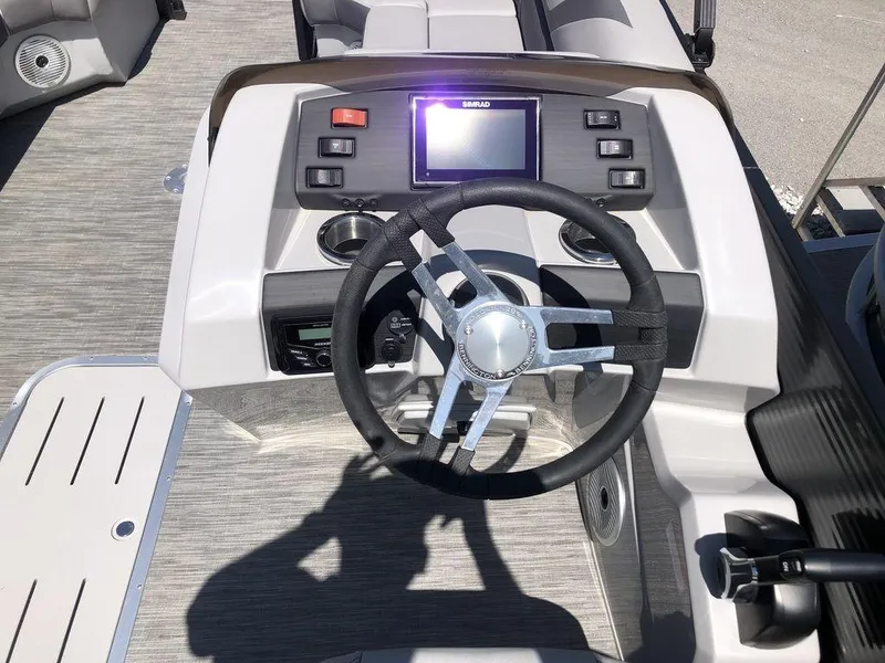 Slide: The Image of 2022 Bennington 22 SSRX boat dashboard with steering wheel and control panel. - 5