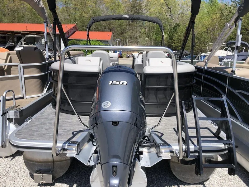 Slide: The Image of 2022 Bennington 22 SSRX pontoon boat with 150 HP engine, docked outdoors. - 7
