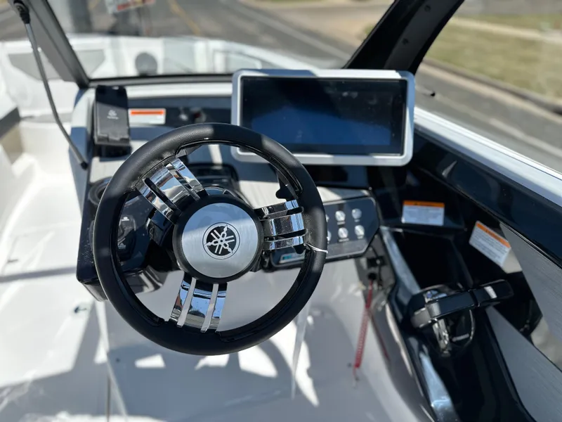 Slide: The Image of 2025 Yamaha Boats 222SD dashboard with steering wheel and touchscreen display. - 11