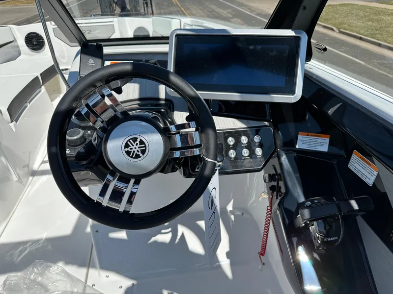 Slide: The Image of 2025 Yamaha Boats 222SD dashboard with steering wheel and touchscreen display. - 12