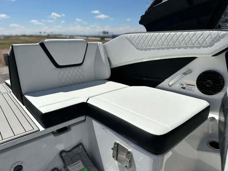 Slide: The Image of 2025 Yamaha Boats 222SD interior seating with white and black upholstery. - 14