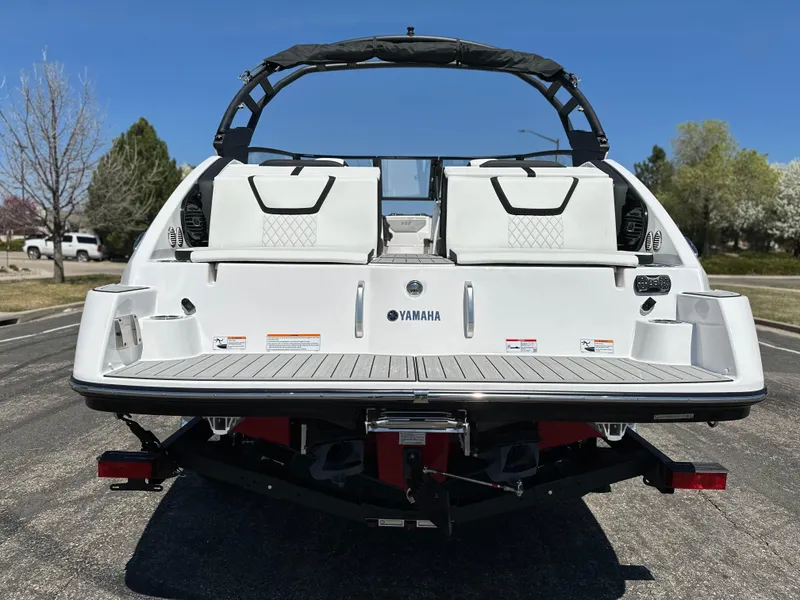Slide: The Image of 2025 Yamaha Boats 222SD, rear view, showcasing sleek design and spacious seating. - 3