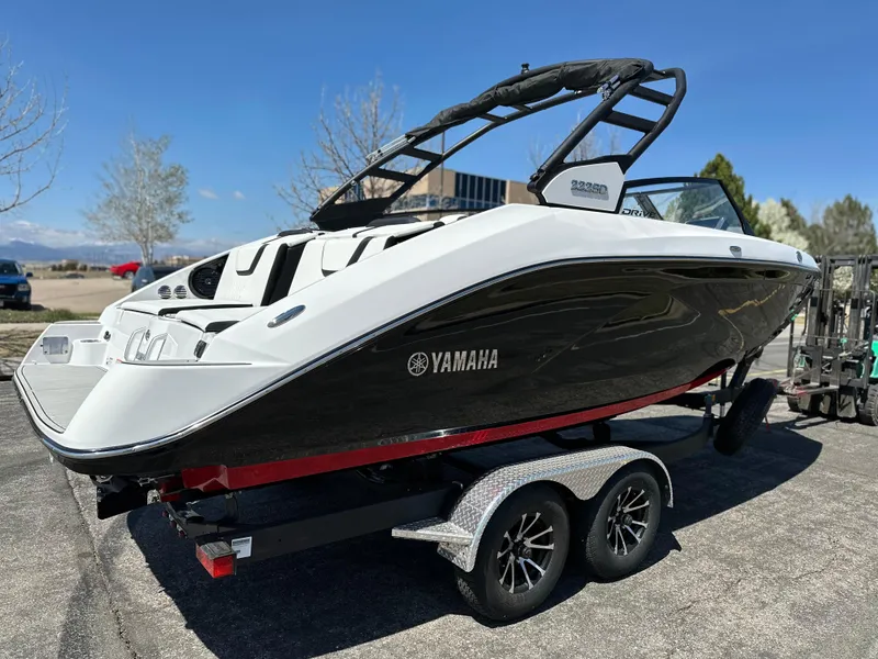 Slide: The Image of 2025 Yamaha Boats 222SD on trailer, sleek design, black and white exterior. - 4