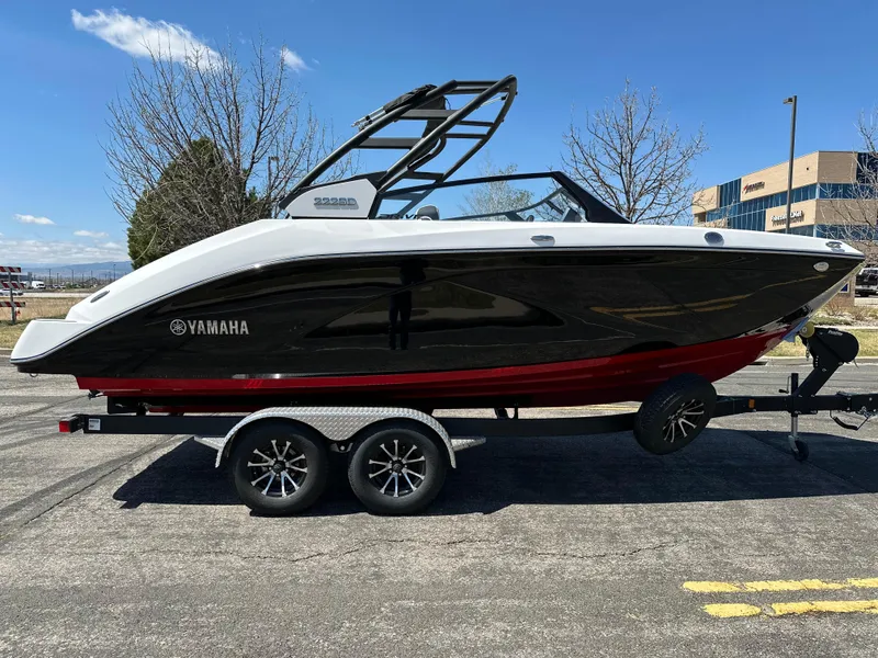 Slide: The Image of 2025 Yamaha Boats 222SD on trailer, black and red design, parked outdoors. - 5