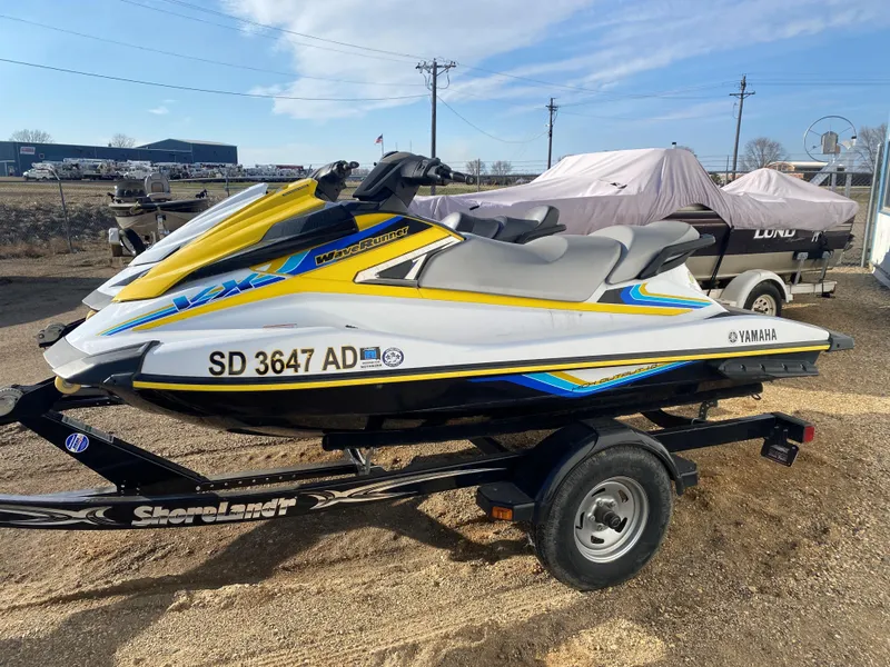 Slide: The Image of 2016 Yamaha WaveRunner personal watercraft on trailer, featuring vibrant yellow and blue accents. - 1