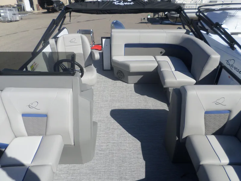 Slide: The Image of 2025 Apex Qwest 818 Lanai boat interior with gray seating and steering wheel. - 3