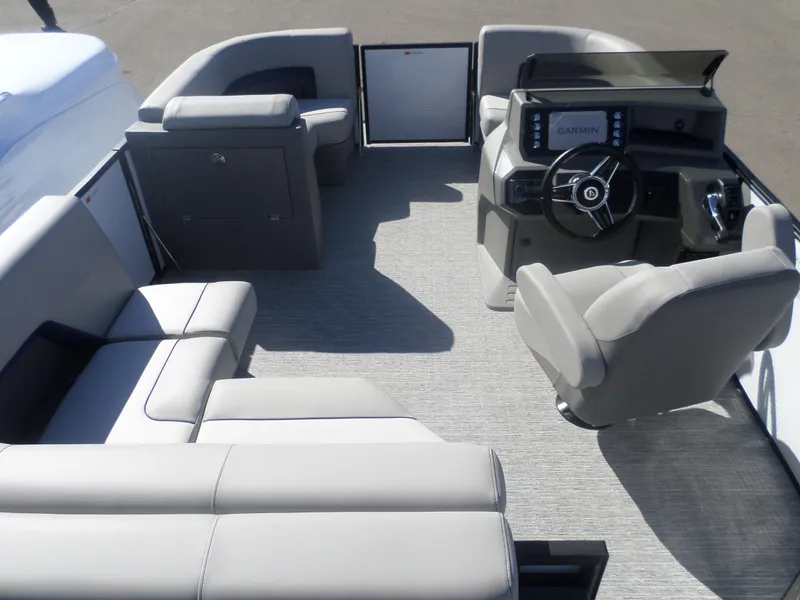 Slide: The Image of 2025 Apex Qwest 818 Lanai boat interior with modern seating and Garmin navigation system. - 4