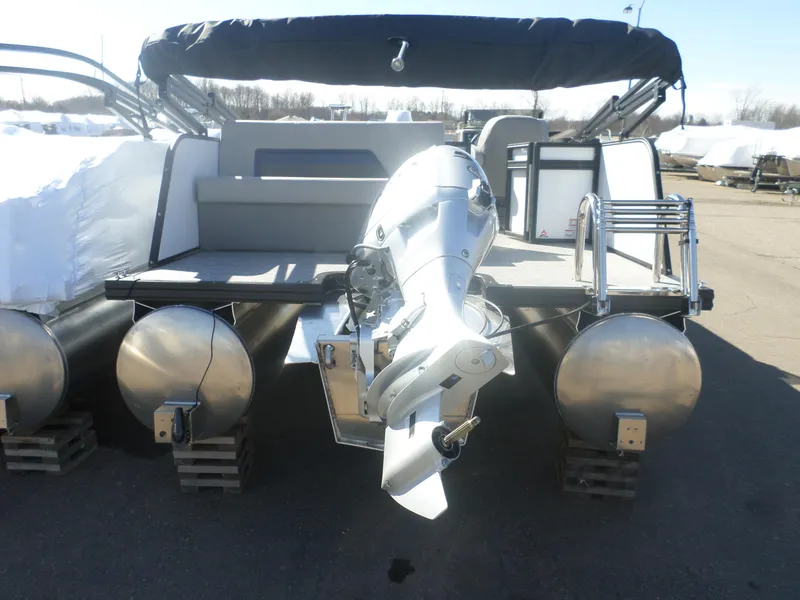Slide: The Image of 2025 Apex Qwest 818 Lanai pontoon boat with outboard motor, docked on land. - 6