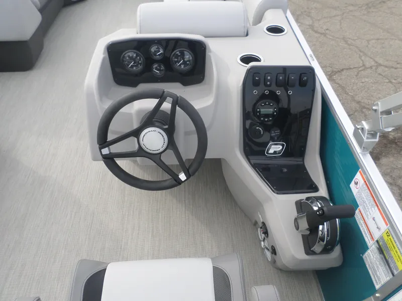 Slide: The Image of 2025 Princecraft Vectra 23 L boat dashboard with steering wheel and control panel. - 5