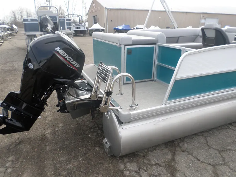 Slide: The Image of 2025 Princecraft Vectra 23 L pontoon boat with Mercury outboard motor, docked on pavement. - 6