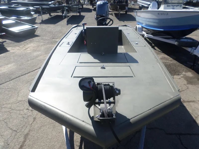 Slide: The Image of 2022 Gator Trax 1862 BIG Water boat, parked on a trailer, showcasing its deck and winch. - 3