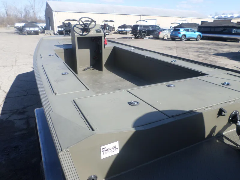 Slide: The Image of 2022 Gator Trax 1862 BIG Water boat in a parking lot, showcasing its spacious deck. - 5