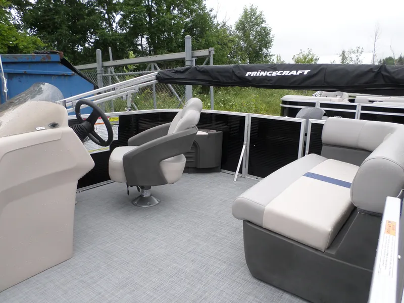 Slide: The Image of 2024 Princecraft Jazz 170 pontoon boat interior with seating and steering console. - 5