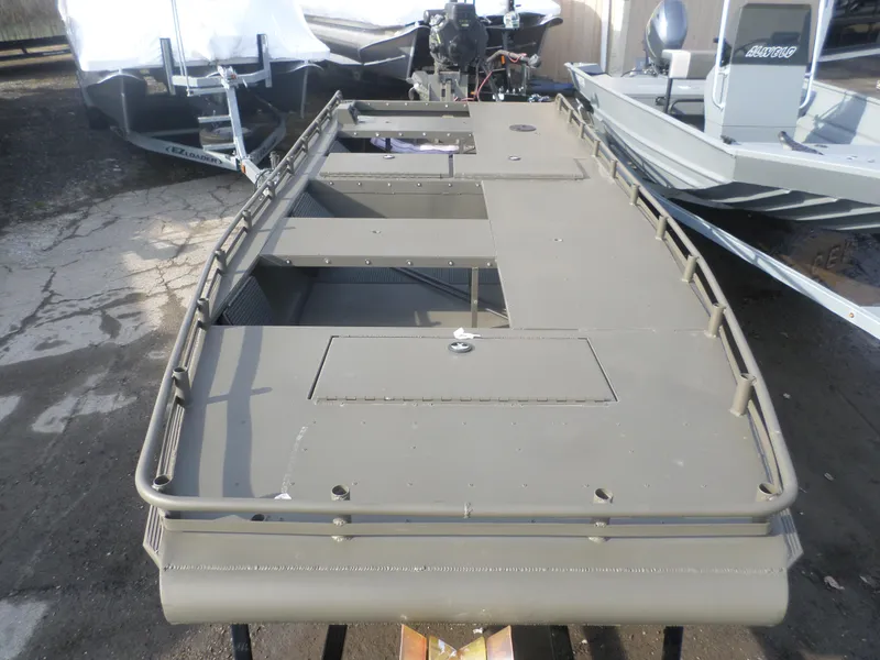 Slide: The Image of 2024 Gator Trax 1862 4 Man Hide boat, olive green, docked outdoors. - 3