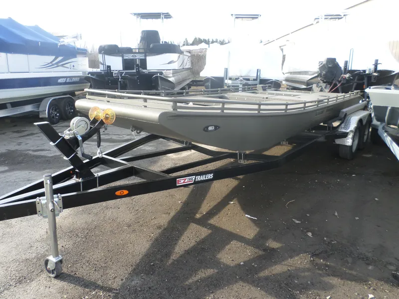 Slide: The Image of 2024 Gator Trax 1862 4 Man Hide boat on trailer, parked outdoors. - 6