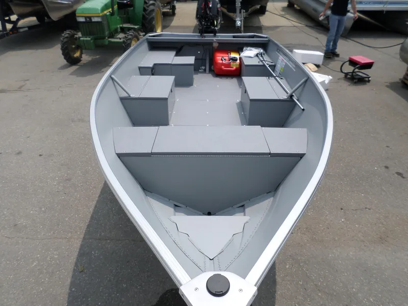 Slide: The Image of 2023 Princecraft Yukon 140 boat, gray interior, parked outdoors. - 3