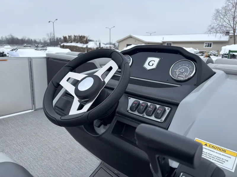 Slide: The Image of 2022 Godfrey Monaco 235 SB boat dashboard with steering wheel and control panel. - 4