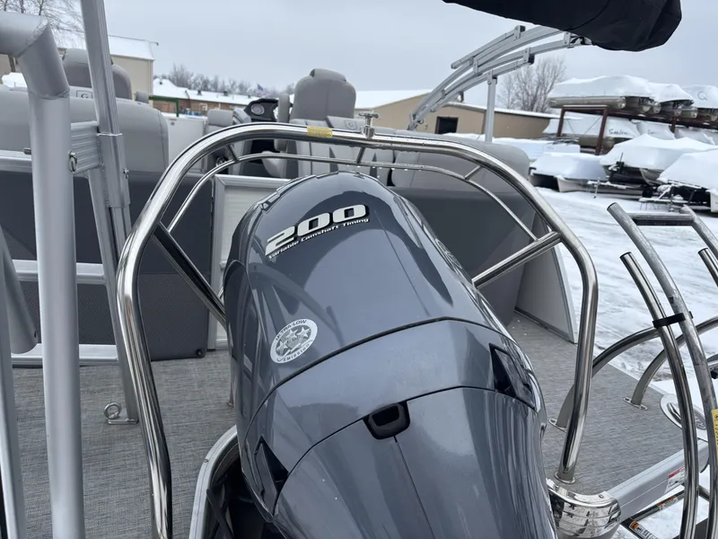 Slide: The Image of 2022 Godfrey Monaco 235 SB boat with 200 horsepower engine, parked in snowy setting. - 5
