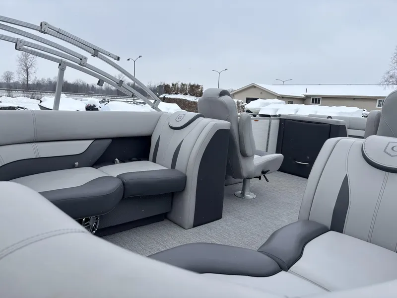 Slide: The Image of 2022 Godfrey Monaco 235 SB boat interior with gray seating and snowy background. - 9