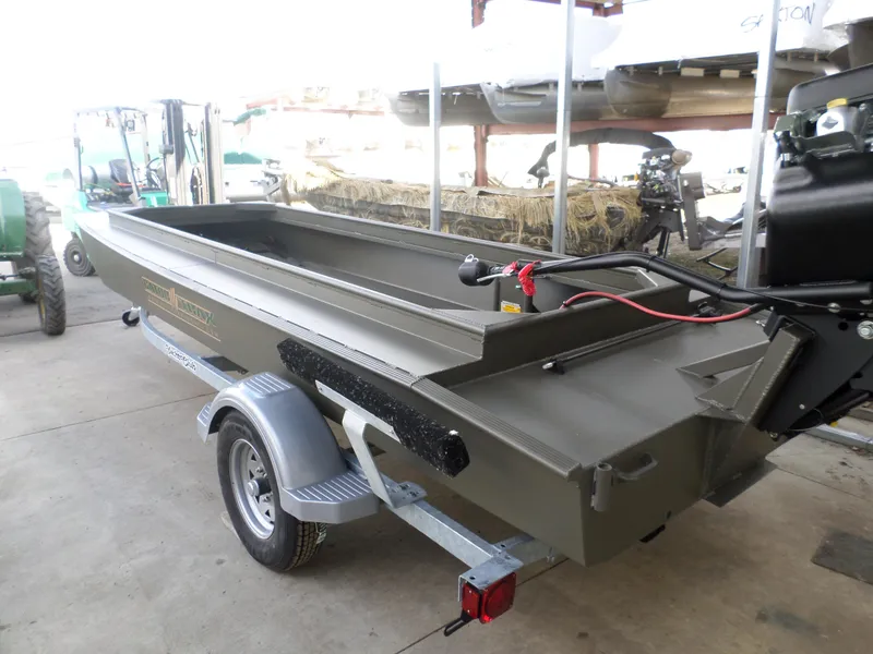 Slide: The Image of 2024 Gator Trax 16 Marsh Series boat on trailer in a storage facility. - 3