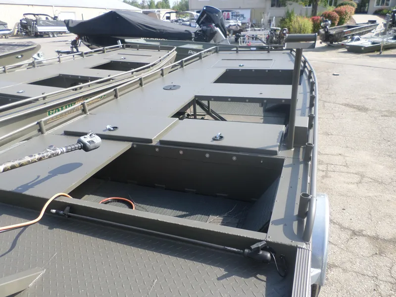 Slide: The Image of 2024 Gator Trax 1862 3 Man Hide boat, showcasing deck and storage compartments. - 2