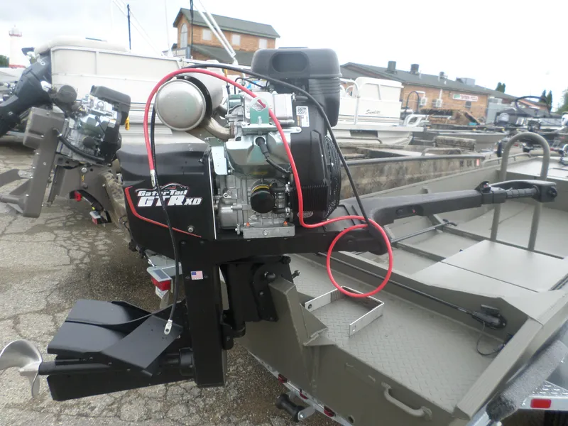 Slide: The Image of 2024 Gator Trax 1544 boat with powerful motor, parked outdoors. - 4