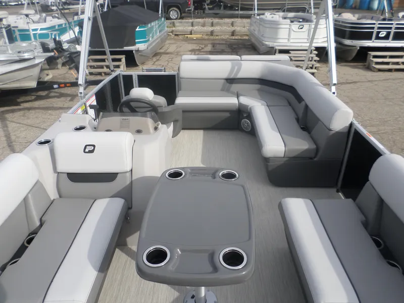 Slide: The Image of 2025 Princecraft Vectra19 L pontoon boat interior with gray seating and table. - 3