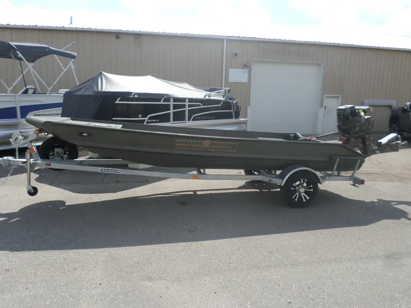 Slide: The Image of 2024 Gator Trax 1644 GE boat on a trailer, parked outdoors. - 1