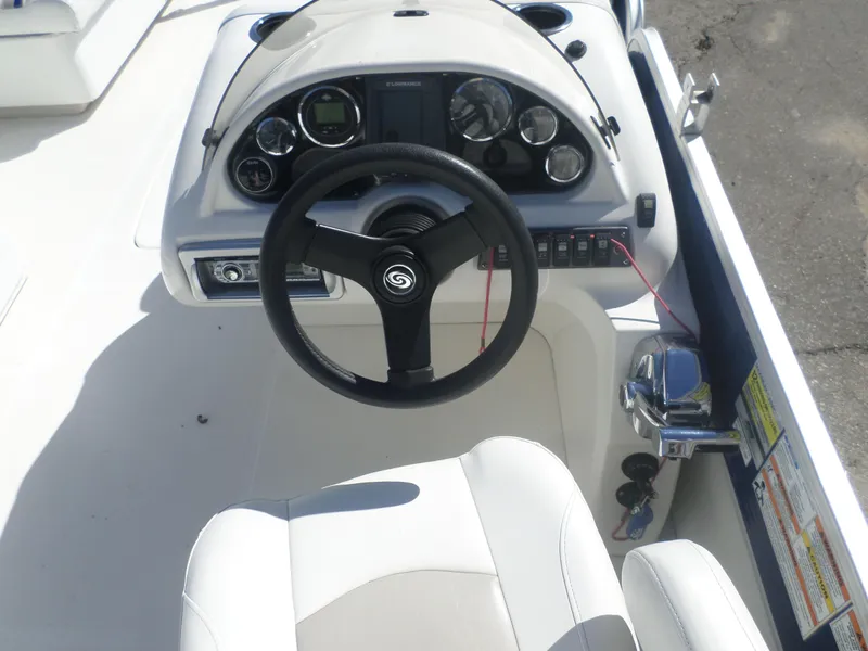Slide: The Image of 2012 Hurricane 236 Fun Deck boat dashboard with steering wheel and control panel. - 3