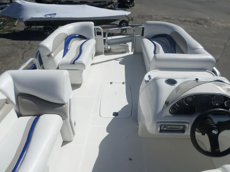 Slide: The Image of 2012 Hurricane 236 Fun Deck boat interior with white seating and steering console. - 5