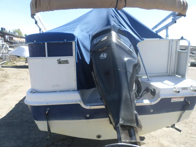 Slide: The Image of 2012 Hurricane 236 Fun Deck boat with outboard motor and blue cover. - 7