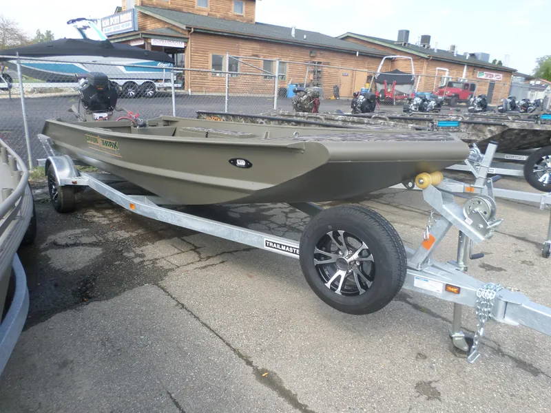 Slide: The Image of 2024 Gator Trax 1750 GE boat on trailer, displayed outdoors near showroom. - 1