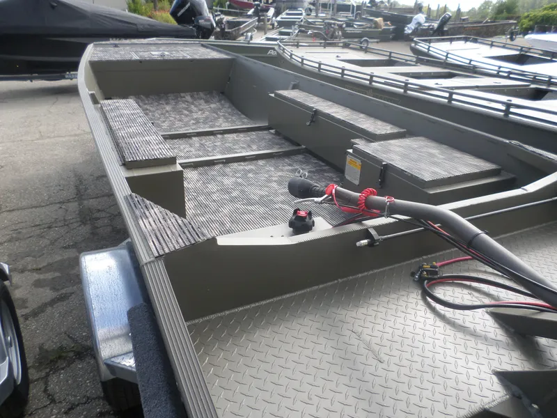 Slide: The Image of 2024 Gator Trax 1750 GE boat with textured flooring and storage compartments. - 2