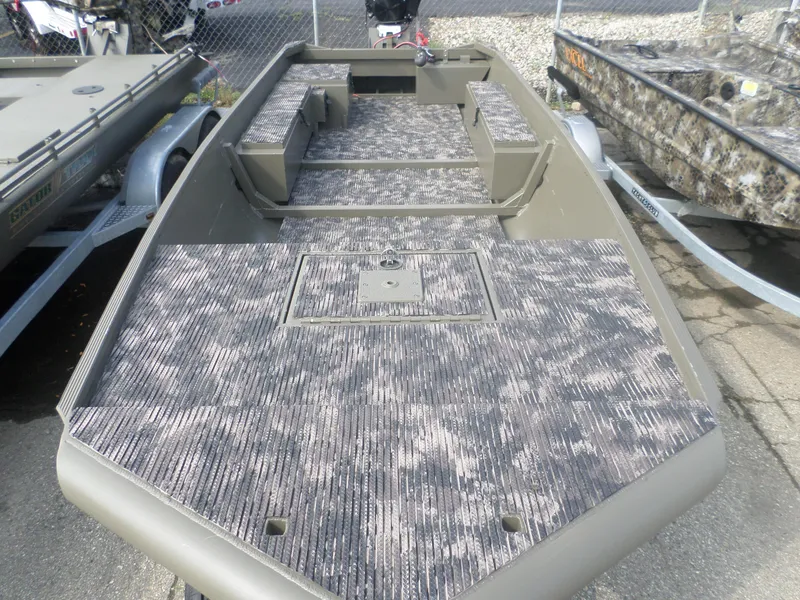 Slide: The Image of 2024 Gator Trax 1750 GE boat with camouflage deck, parked on a trailer. - 3