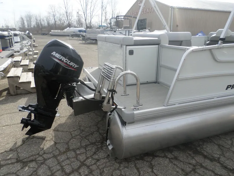 Slide: The Image of 2025 Princecraft Vectra 19 L pontoon boat with Mercury outboard motor, docked outdoors. - 3