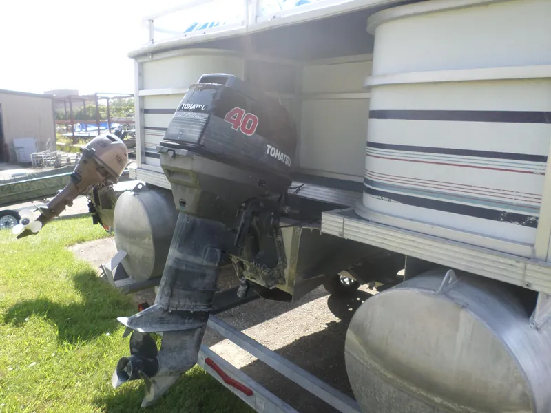 Slide: The Image of 1994 Manitou 24 pontoon boat with Tohatsu outboard motors on a trailer. - 4
