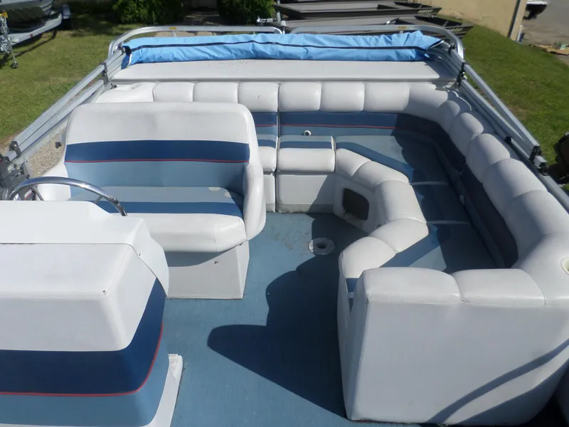 Slide: The Image of 1994 Manitou 24 pontoon boat interior with blue and white seating arrangement. - 5