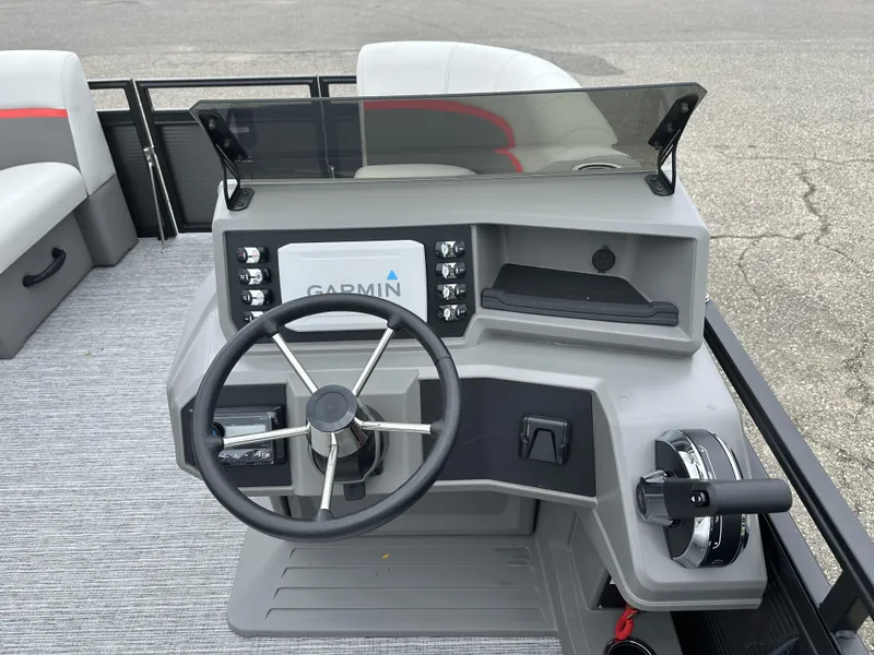 Slide: The Image of 2024 Apex Qwest 8516 Lanai boat dashboard with Garmin navigation system and steering wheel. - 3