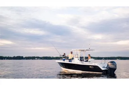 Slide: The Image of 2022 Sea Hunt Ultra 229 boat on calm water with people fishing. - 11