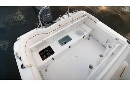 Slide: The Image of 2022 Sea Hunt Ultra 229 boat deck with storage compartments and rod holders. - 12