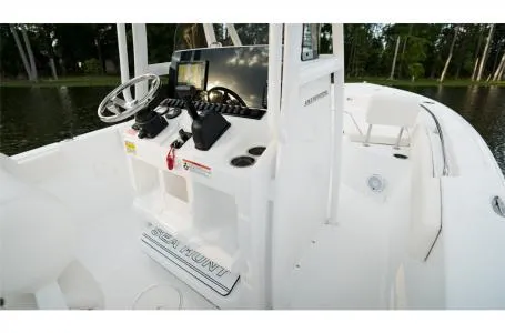 Slide: The Image of 2022 Sea Hunt Ultra 229 boat interior with steering console and seating. - 20