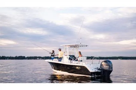 Slide: The Image of 2022 Sea Hunt Ultra 229 boat on calm water with people fishing. - 3