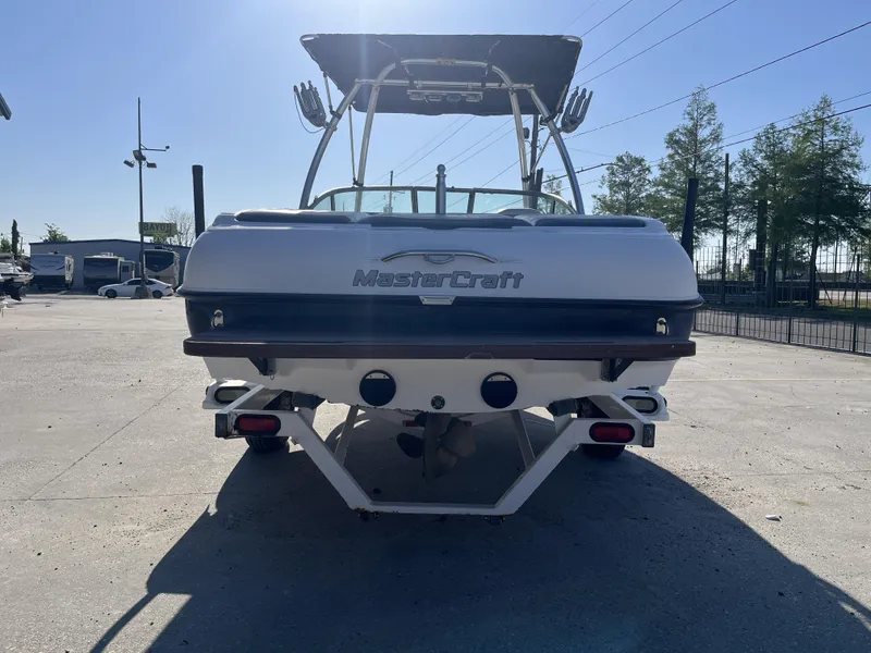 Slide: The Image of 2006 MasterCraft MariStar 210 boat, rear view, parked outdoors on a sunny day. - 13