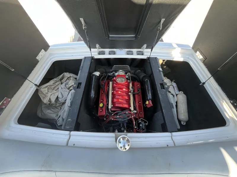 Slide: The Image of 2006 MasterCraft MariStar 210 engine compartment with red engine and storage areas. - 17