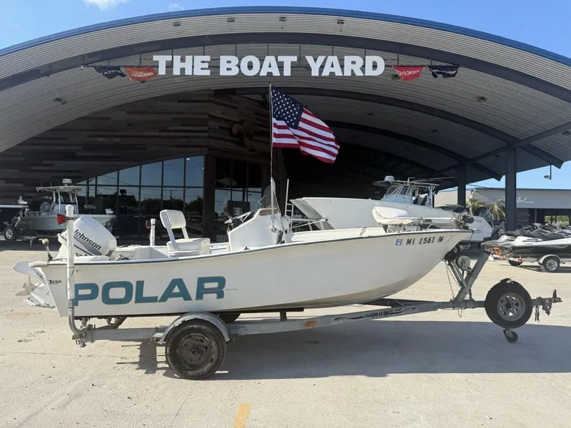 Slide: The Image of 1997 Polar 17 CC boat on trailer at The Boat Yard, displaying American flag. - 1