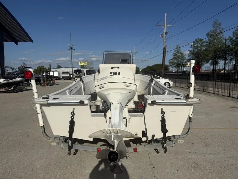 Slide: The Image of 1997 Polar 17 CC boat with outboard motor, parked outdoors on a sunny day. - 13