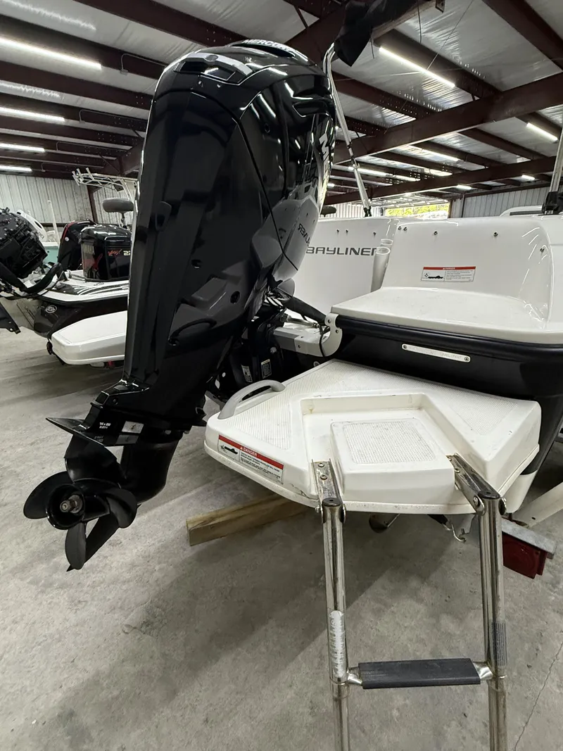 Slide: The Image of 2022 Bayliner Element E18 boat with outboard motor and swim platform in a showroom. - 7