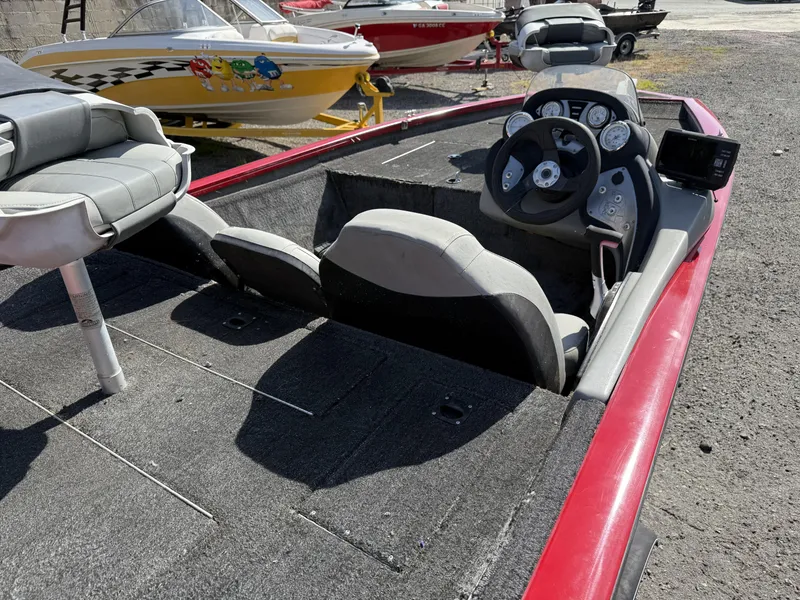 Slide: The Image of 2017 Tracker Pro Team 175 TXW boat interior with steering console and seating. - 10
