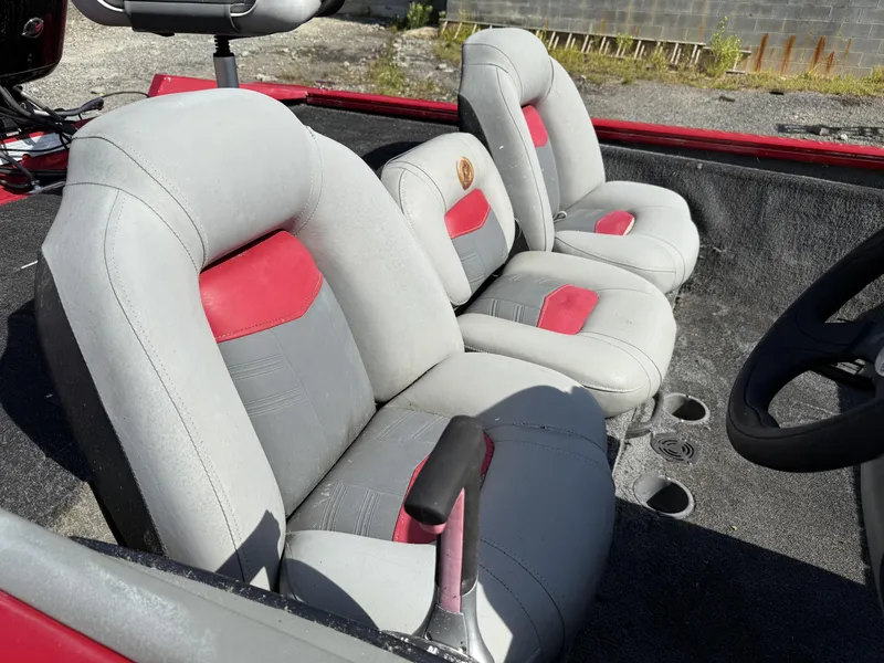 Slide: The Image of 2017 Tracker Pro Team 175 TXW boat interior with gray and red seats. - 11