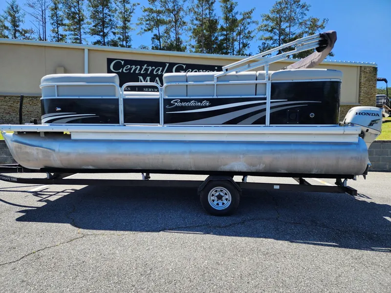 Slide: The Image of 2012 Sweetwater SW 2086 pontoon boat on trailer, parked outdoors. - 1